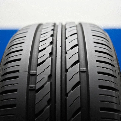 Close-up of a car tire being inspected for repair, focusing on the tread area