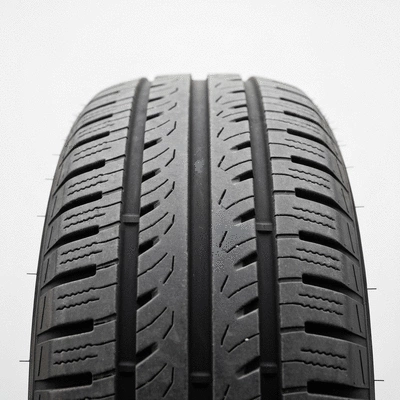 Car tire with visible wear patterns on a clean background